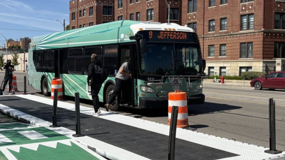 DDOT bus stays in traffic lane as people board from new elevated platform.
