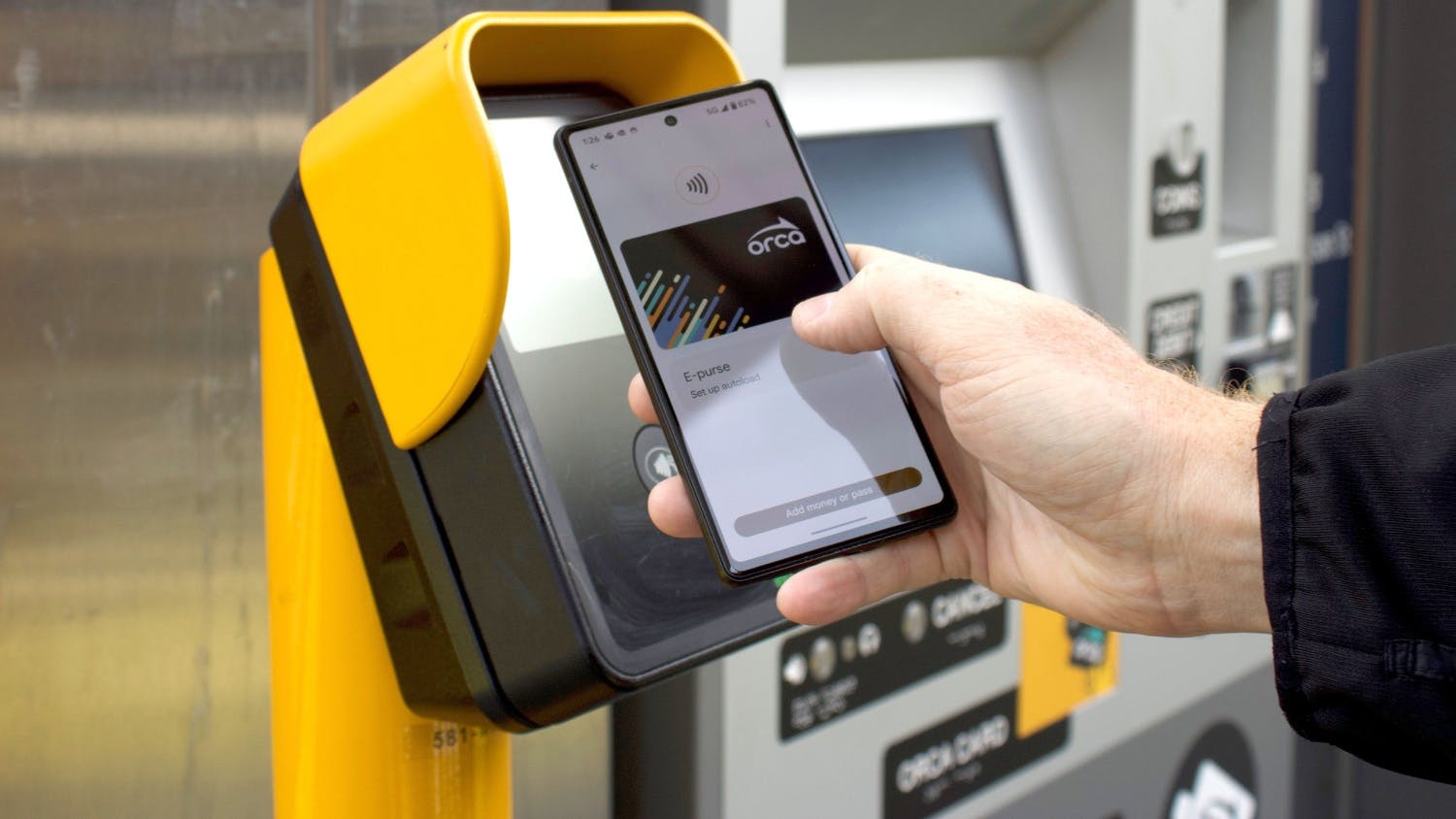 A rider taps their Android phone to an ORCA-enabled payment terminal.