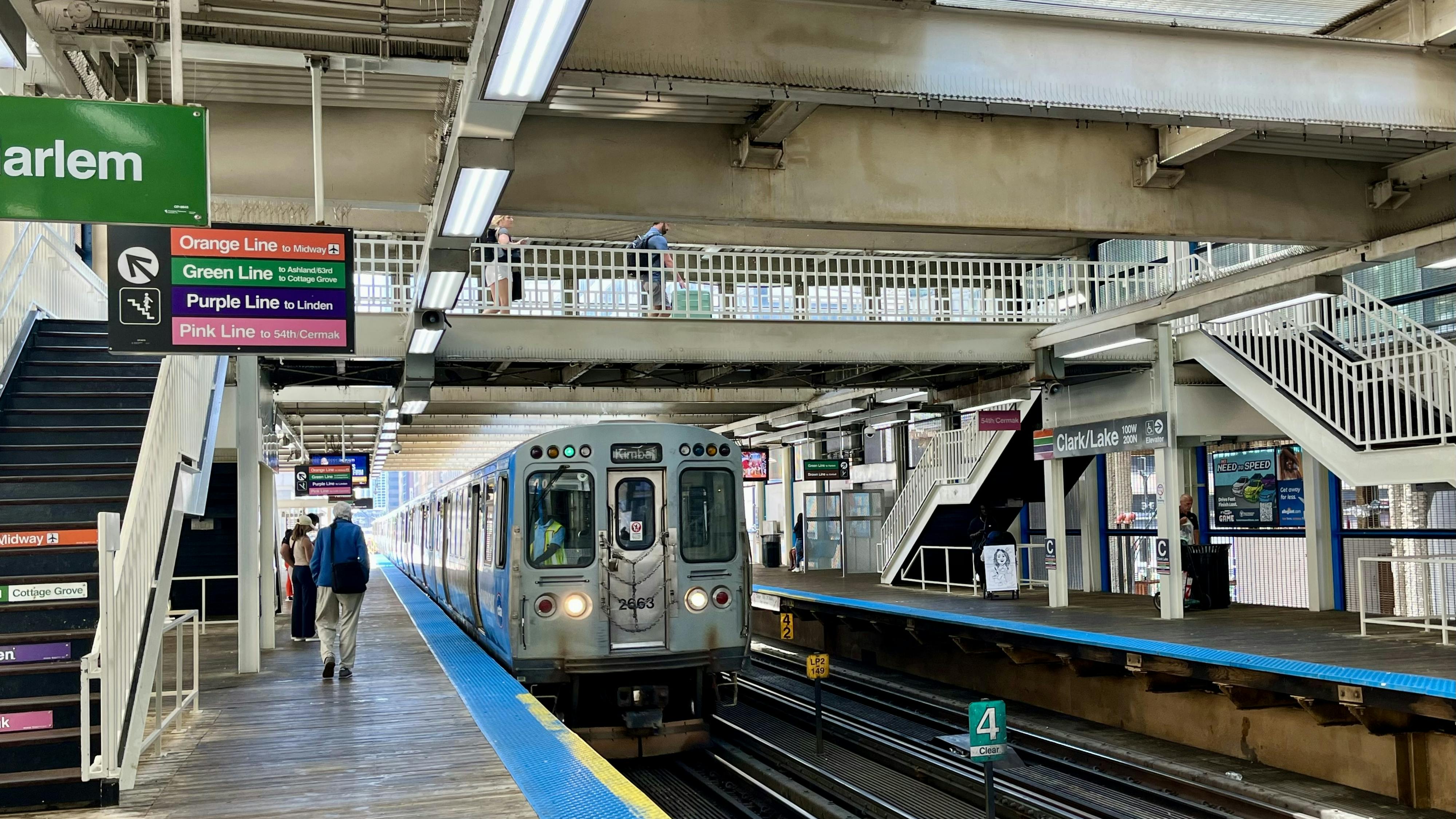 Passengers walk to in incoming subway train.