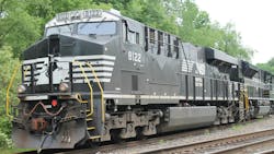 A Norfolk Southern locomotive sits in a rail yard. A Norfolk Southern locomotive sits in a rail yard.
