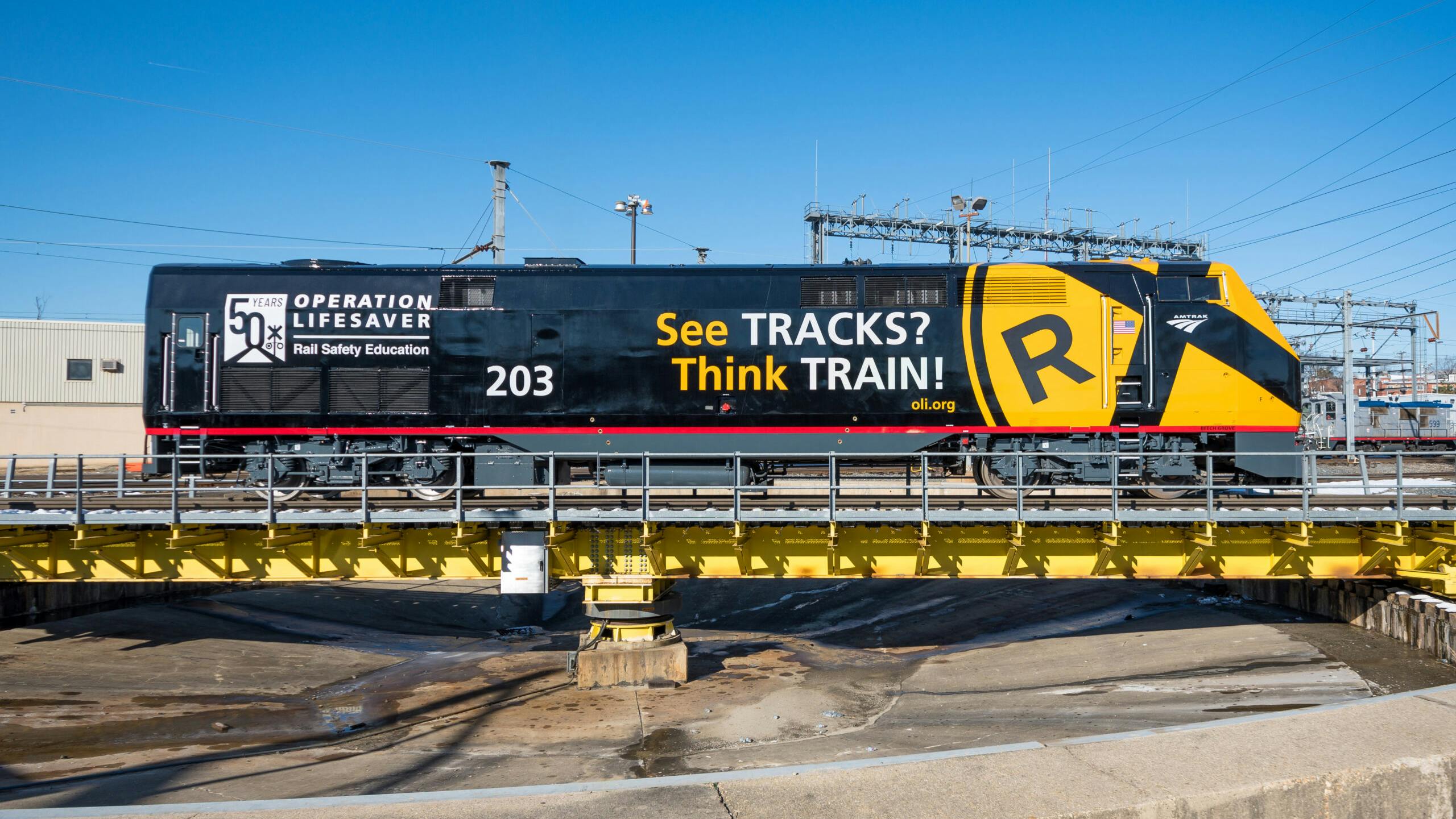 An Amtrak train wrapped with promotion of Operation Lifesaver's See Tracks? Think Train&circledR; Week.