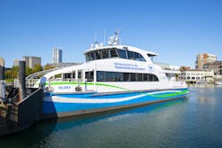 The image shows an MBTA ferry on the water. The image shows an MBTA ferry on the water.