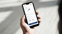 An iPhone displays the Chandler Flex app offering a Waymo ride.