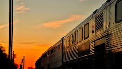 A Metra train travels at sunset. A Metra train travels at sunset.
