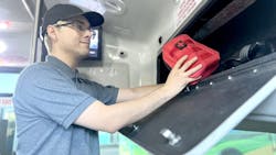 The image displays a man stocks a VVTA vehicle with NARCAN. The image displays a man stocks a VVTA vehicle with NARCAN.