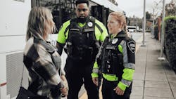 Community Transit Transit Security Officers with a customer. Community Transit Transit Security Officers with a customer.