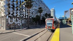 A light-rail car moves down the street. A light-rail car moves down the street.
