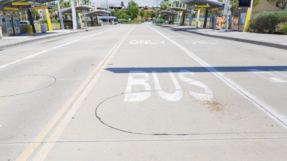 The image shows a bus only lane on a street.