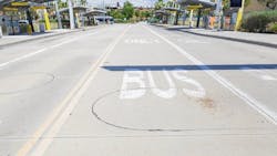 The image shows a bus only lane on a street. The image shows a bus only lane on a street.