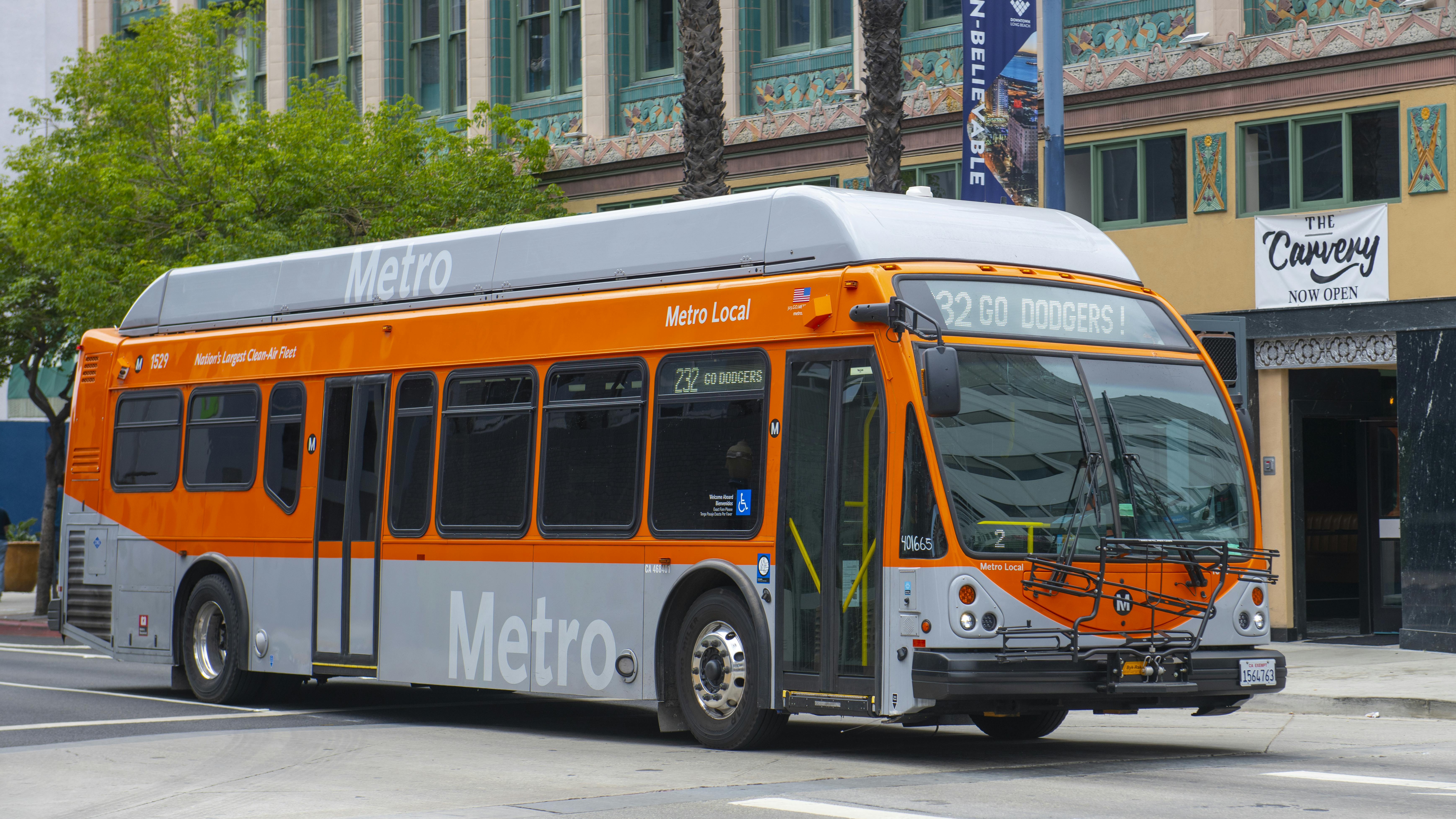 The image shows a L.A. Metro bus driving down a street.