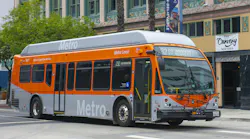 The image shows a L.A. Metro bus driving down a street.