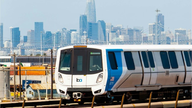 A BART train moves down the track.