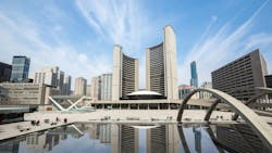 The image features a wide shot of the Toronto City Hall. The image features a wide shot of the Toronto City Hall.