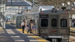 The image shows riders boarding a subway. The image shows riders boarding a subway.