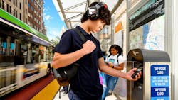 A passenger taps their phone to a Clipper vending machine. A passenger taps their phone to a Clipper vending machine.