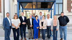 City leaders stand posed in front of the new bus shelter.