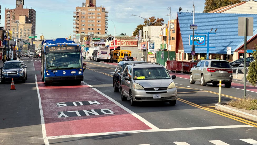 An MTA bus comes to an intersection in a bus-only lane.