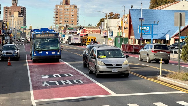 An MTA bus comes to an intersection in a bus-only lane.