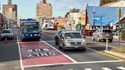 An MTA bus comes to an intersection in a bus-only lane. An MTA bus comes to an intersection in a bus-only lane.