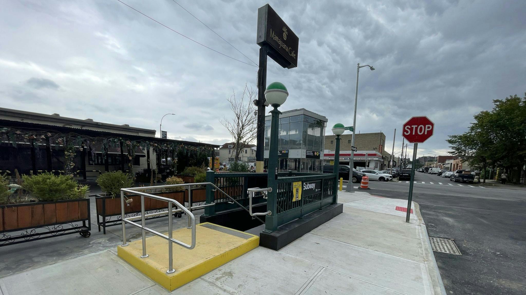 The image shows an entrance to the Northern Blvd. M and R subway station.