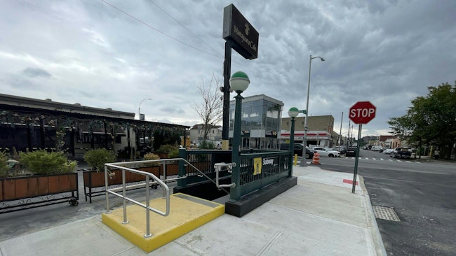 The image shows an entrance to the Northern Blvd. M and R subway station.