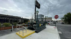 The image shows an entrance to the Northern Blvd. M and R subway station.