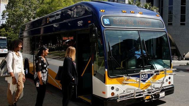 Passengers board a SacRT bus.