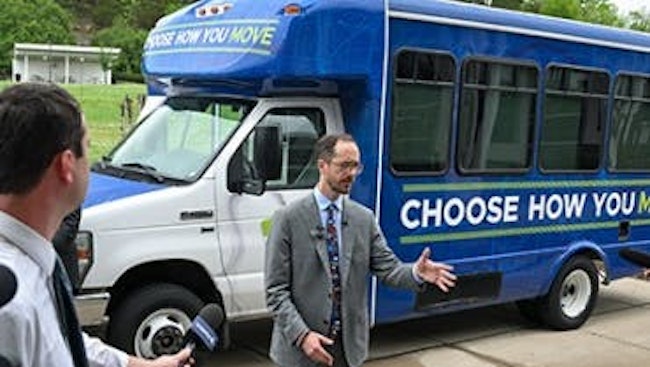 The image displays a Mayor unveiling the new lane.