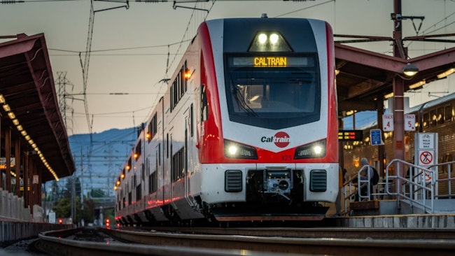 A Caltrain train pulls away from a station.