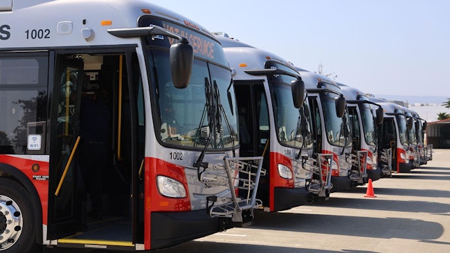 A line of SamTrans buses sits in waiting.