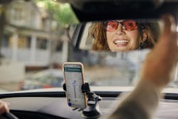 A Lyft driver adjusts the car mirror. A Lyft driver adjusts the car mirror.