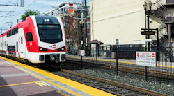 Double-decker Caltrain electric train approaches a station.