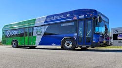 The image shows the new Pace hybrid bus staged in a parking lot. The image shows the new Pace hybrid bus staged in a parking lot.