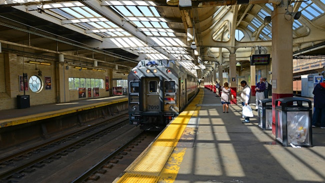 The image shows an existing multilevel car pulling out of the station.