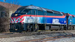 The image shows a Metra train moving along the track.