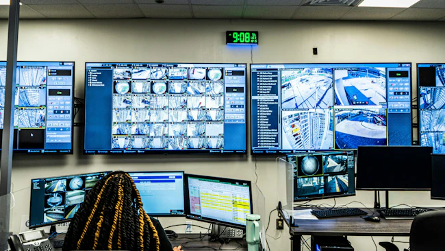 A security agent watches the real-time camera feeds at the real-time camera center.