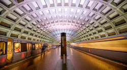 WMATA trains pass through a station.