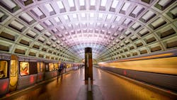 WMATA trains pass through a station. WMATA trains pass through a station.