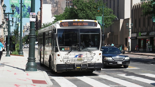 A NJ Transit bus drives down the street.