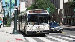 A NJ Transit bus drives down the street. A NJ Transit bus drives down the street.