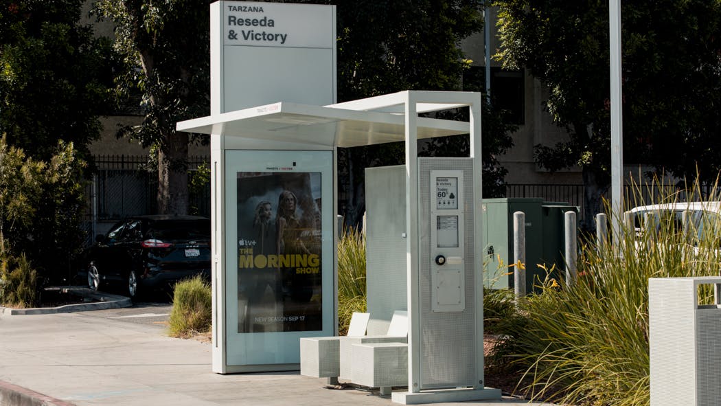 The image displays a Tolar bus shelter erected in Los Angeles.