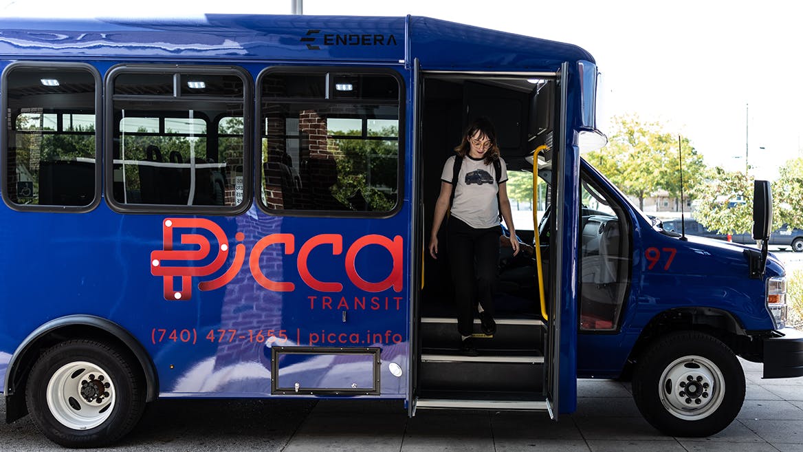 A rider exits a transit bus.
