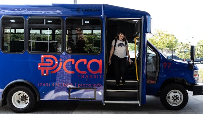 A rider exits a transit bus.