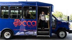 A rider exits a transit bus. A rider exits a transit bus.