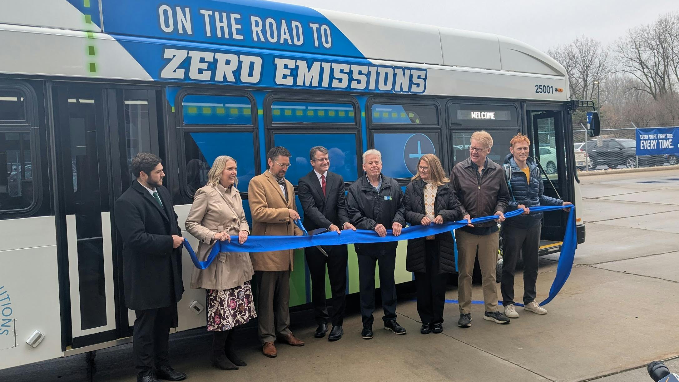 CATA and local leaders hold a ribbon for a ribbon cutting for the new bus.