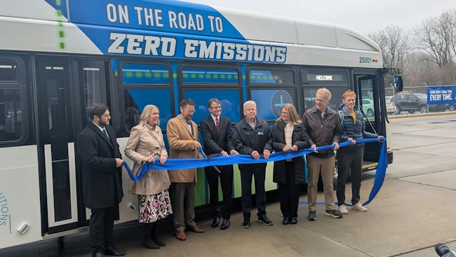 CATA and local leaders hold a ribbon for a ribbon cutting for the new bus.