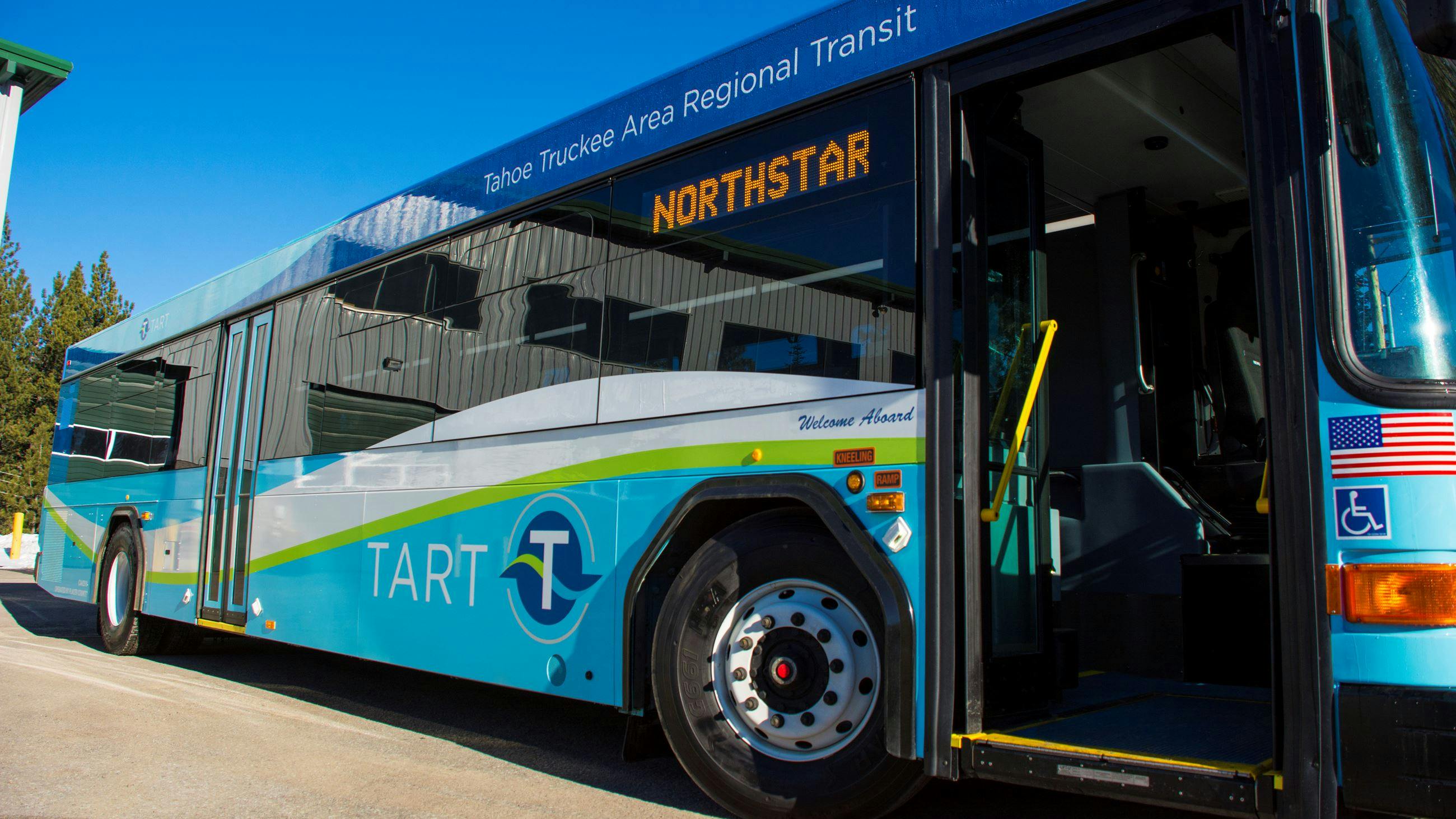 A TART bus sits with its door open.