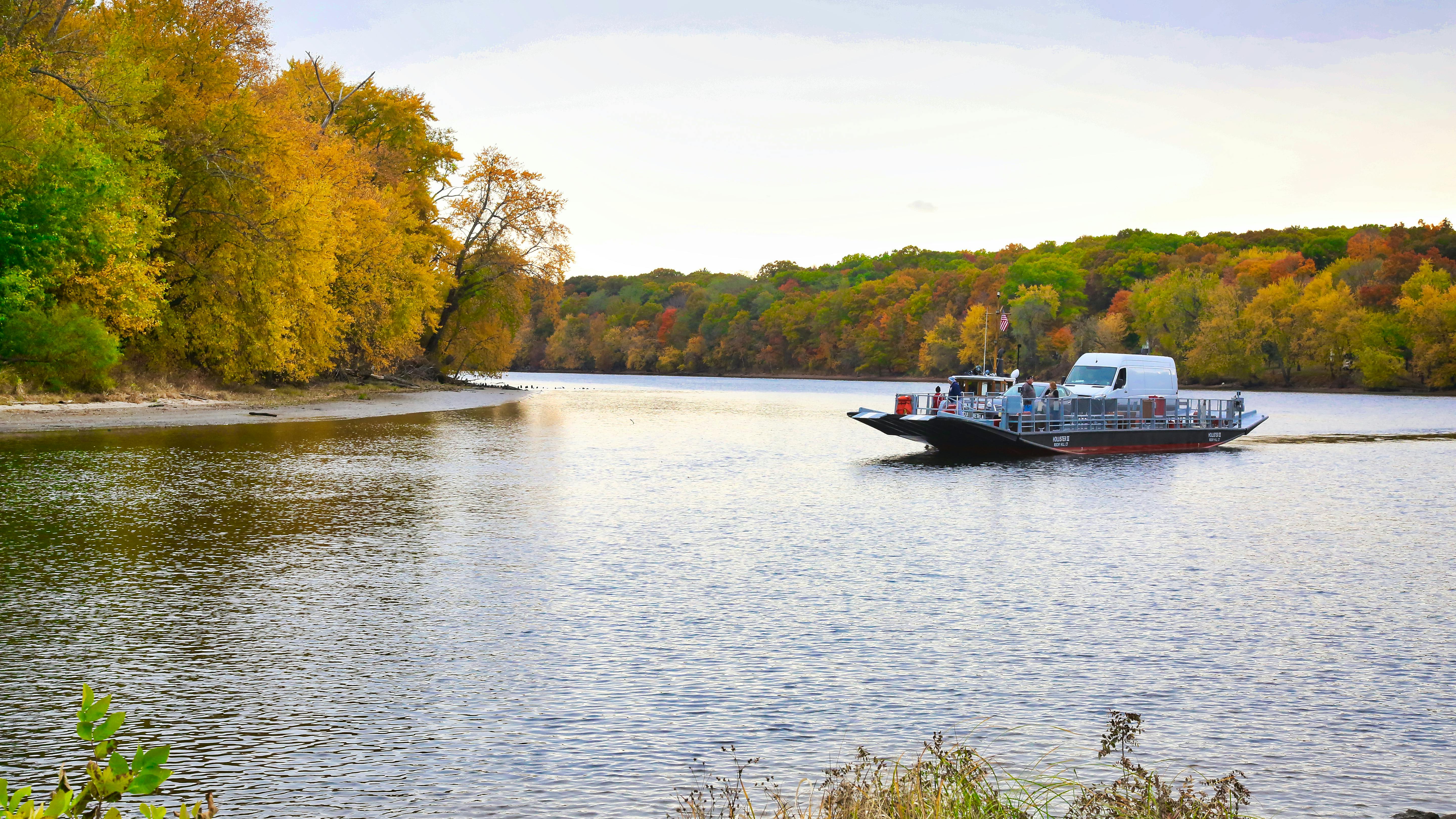 A Glastonbury Ferry crosses the water.