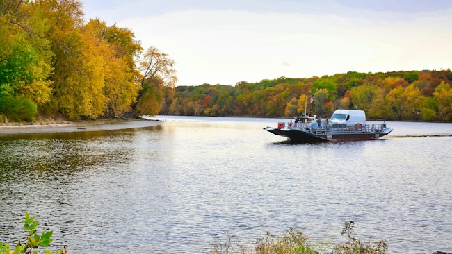 A Glastonbury Ferry crosses the water.