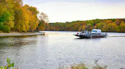A Glastonbury Ferry crosses the water.